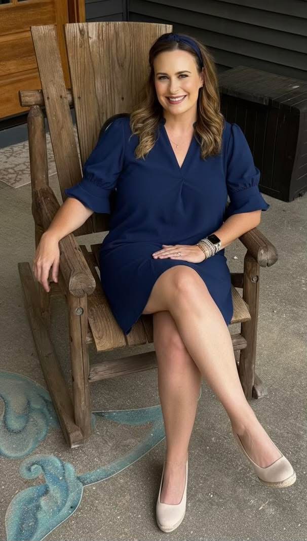 Mandy Serpas seated in a navy dress